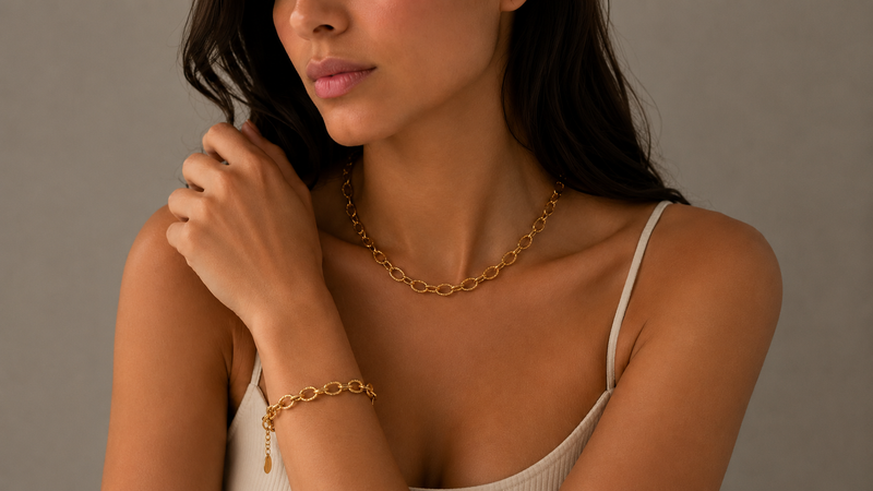 Model wearing bold style gold chain and bracelet