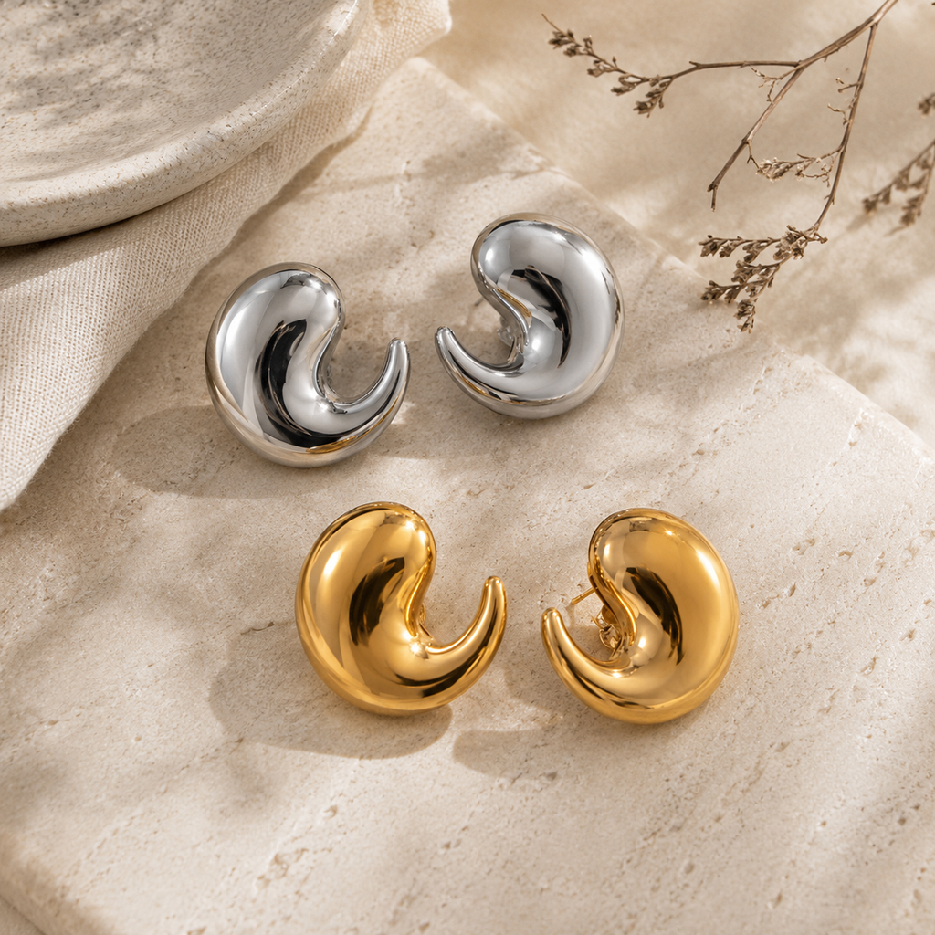 Gold and silver polished crescent-shaped earrings.