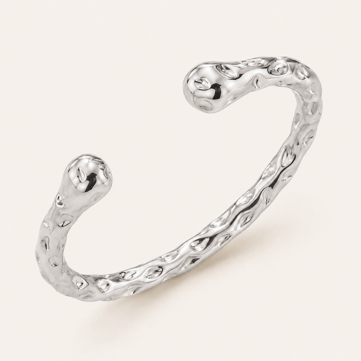 A textured silver open cuff bracelet with a wavy, organic shape and polished finish.