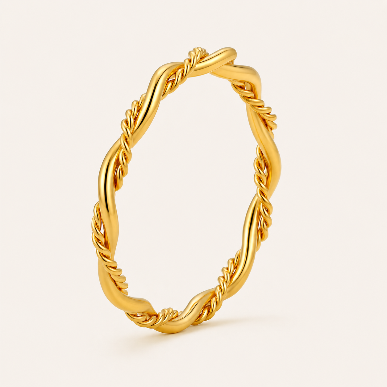 A twisted rope-style gold ring with a polished finish.