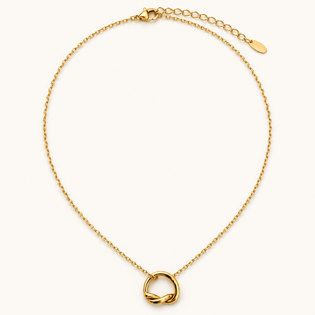 A delicate gold chain necklace with a small interlocking love-knot pendant.