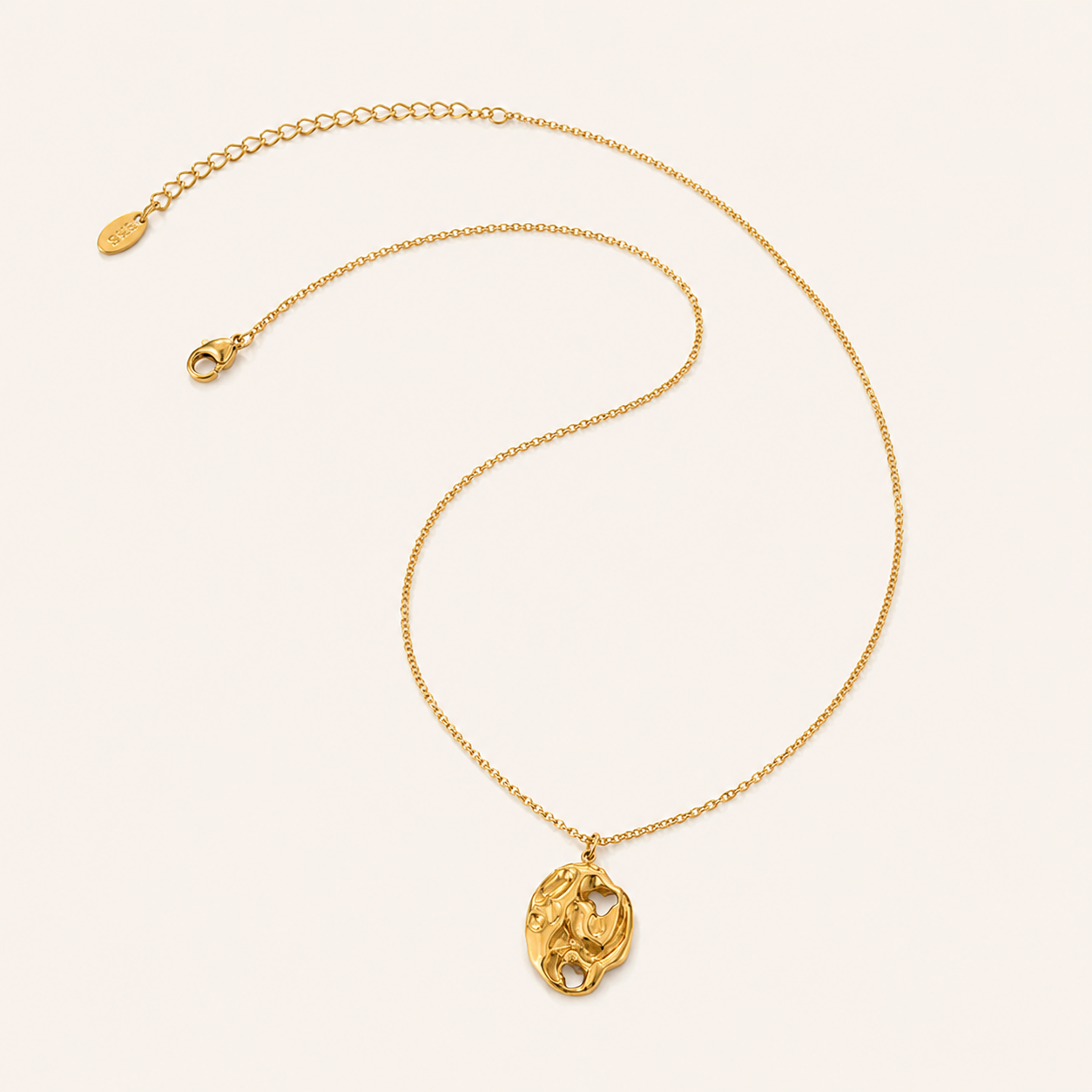 A delictae gold necklace with pendant - hammered, natural look.