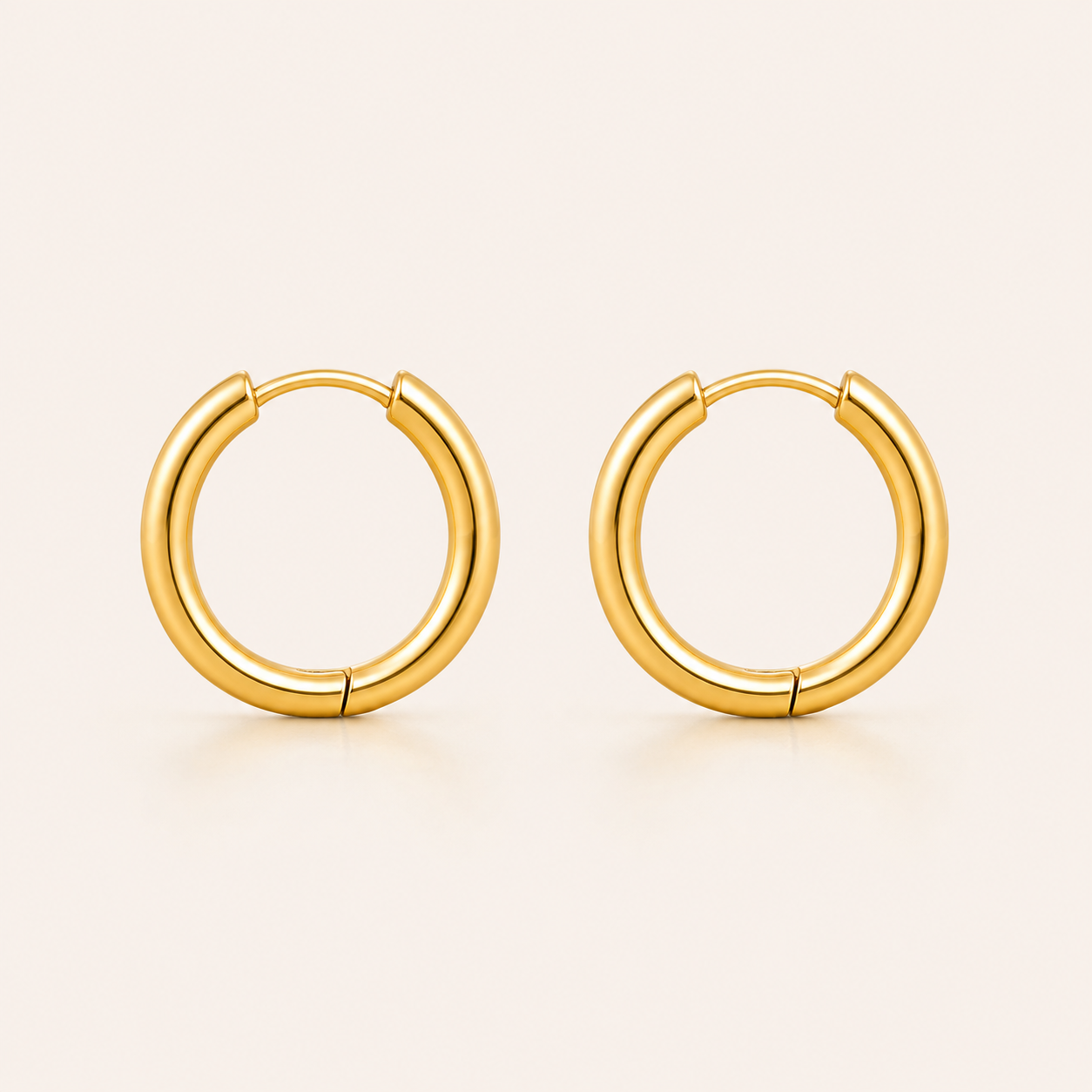 A pair of polished gold hoop earrings.