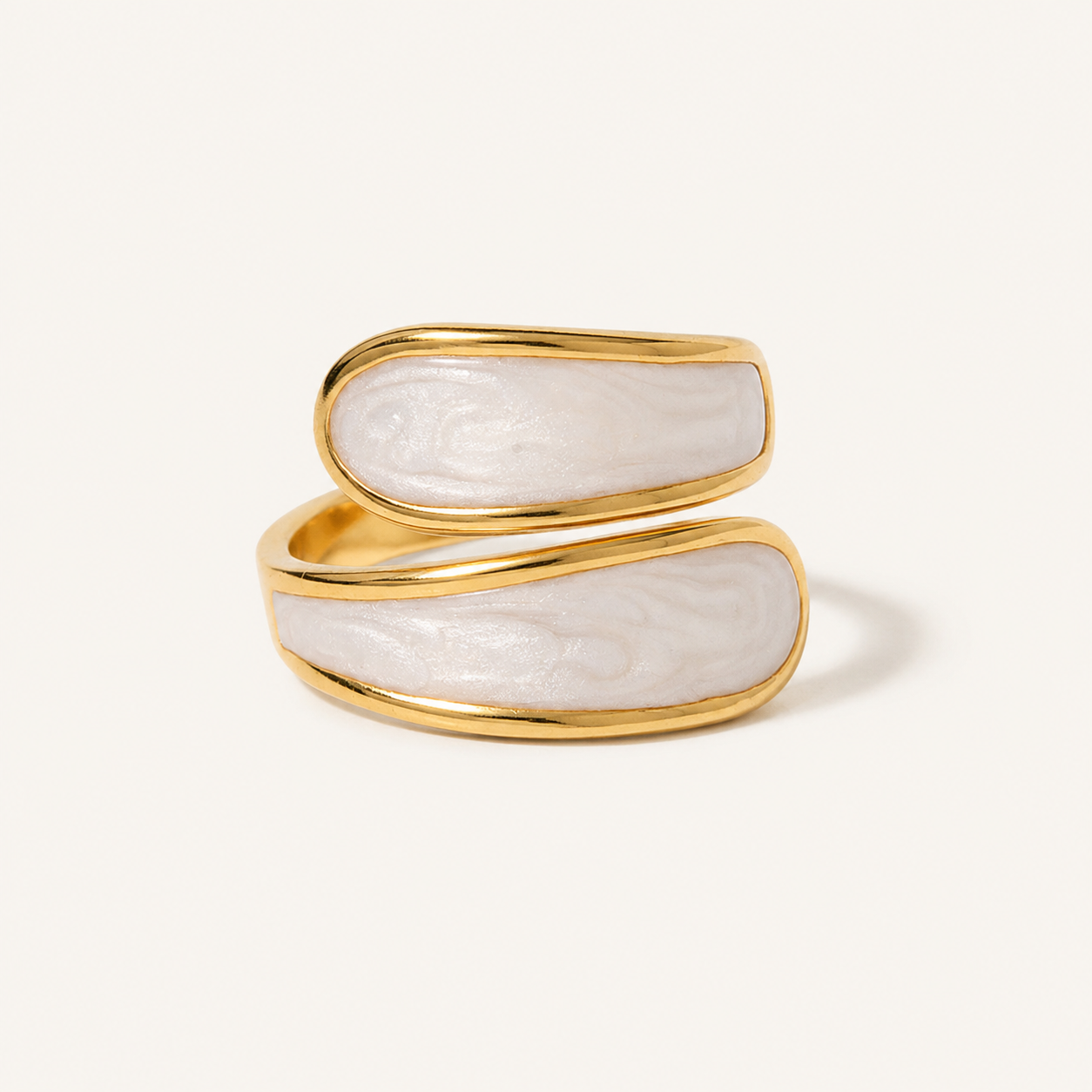 A gold open ring featuring two horizontal oval sections with a white, marbled mother-of-pearl inlay.