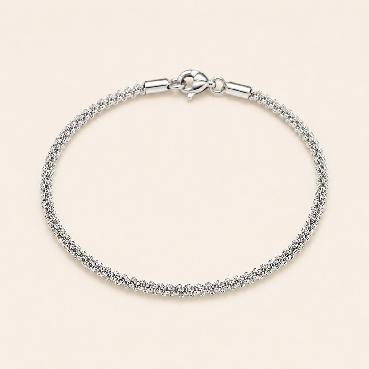A silver chain bracelet with a textured woven-style design and a lobster clasp.