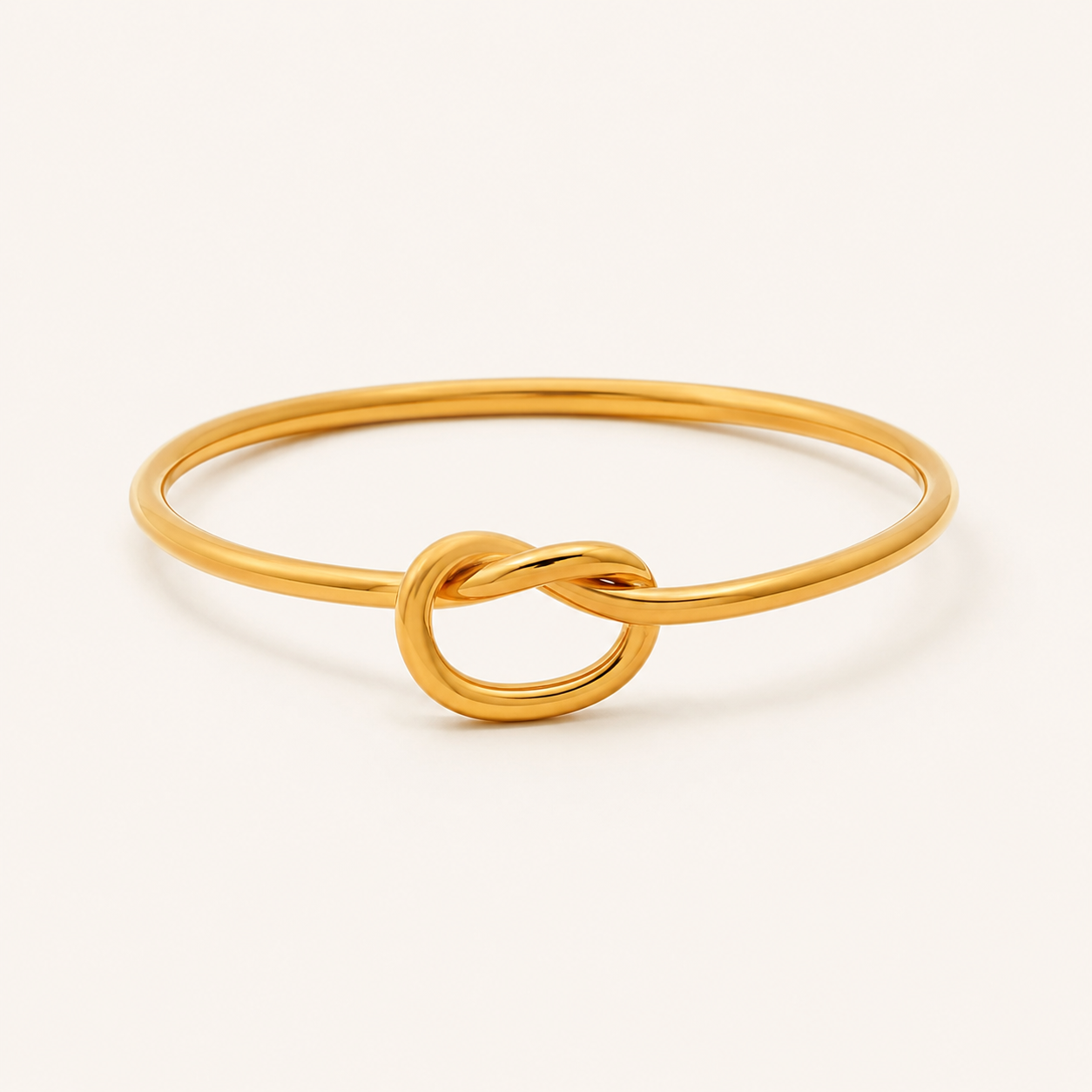 A polished gold ring featuring a central infinity love knot design.