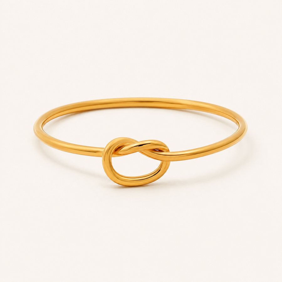 A polished gold ring featuring a central infinity love knot design.