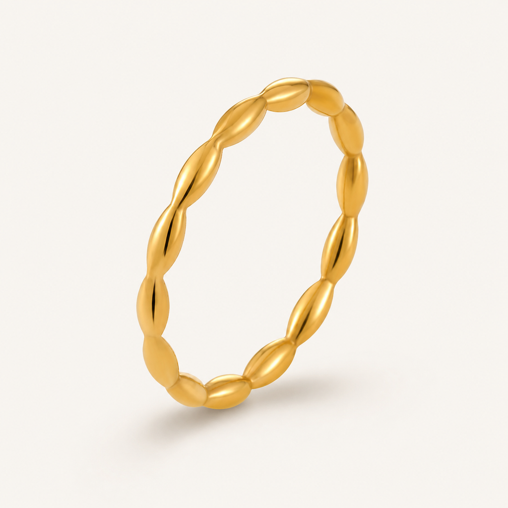 A single gold ring with a textured, twisted oval design.