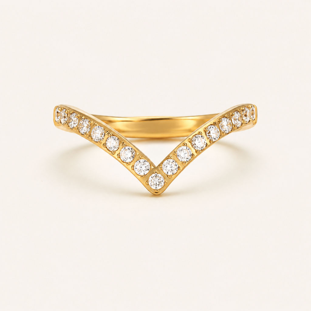 A gold V-shaped ring with pavé-set round zircon stones.