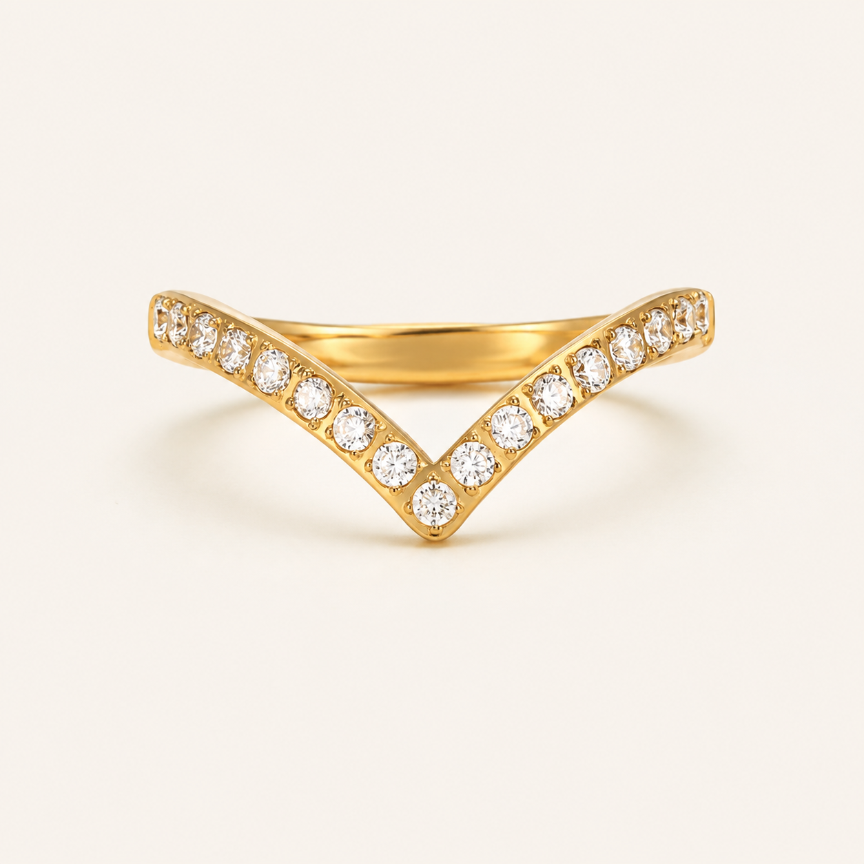 A gold V-shaped ring with pavé-set round zircon stones.