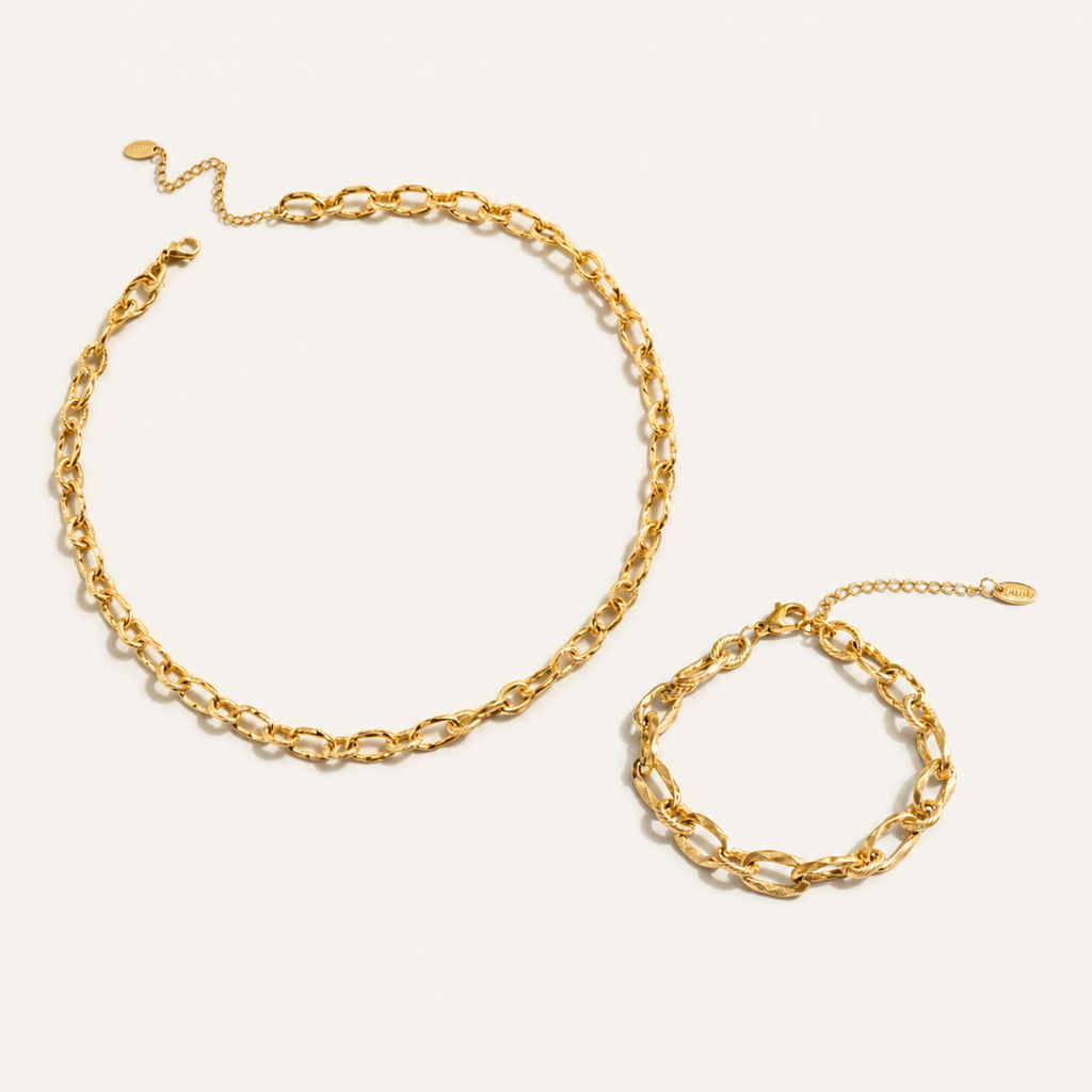 A gold chain necklace and matching gold chain bracelet with elongated oval links.