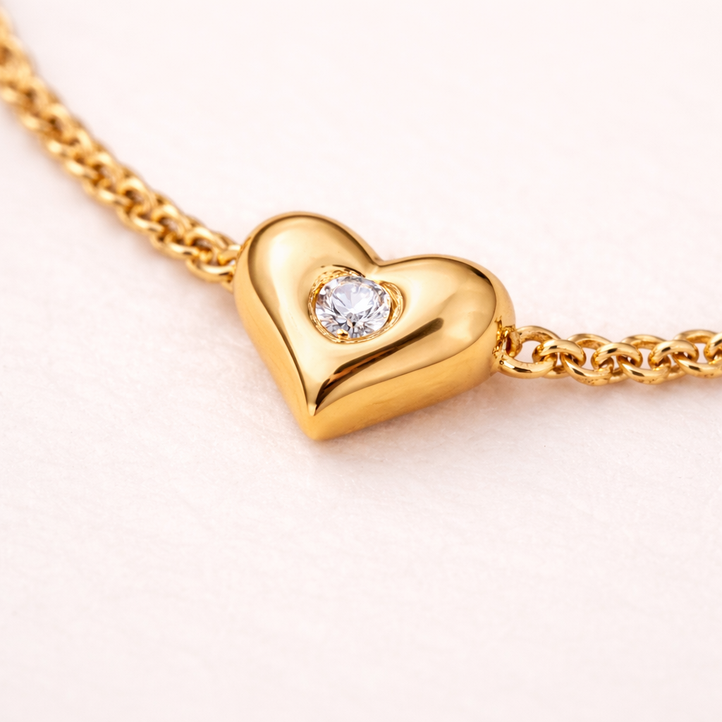 The Amora design featuring a small heart and a round cubic zirconia stone at its centre