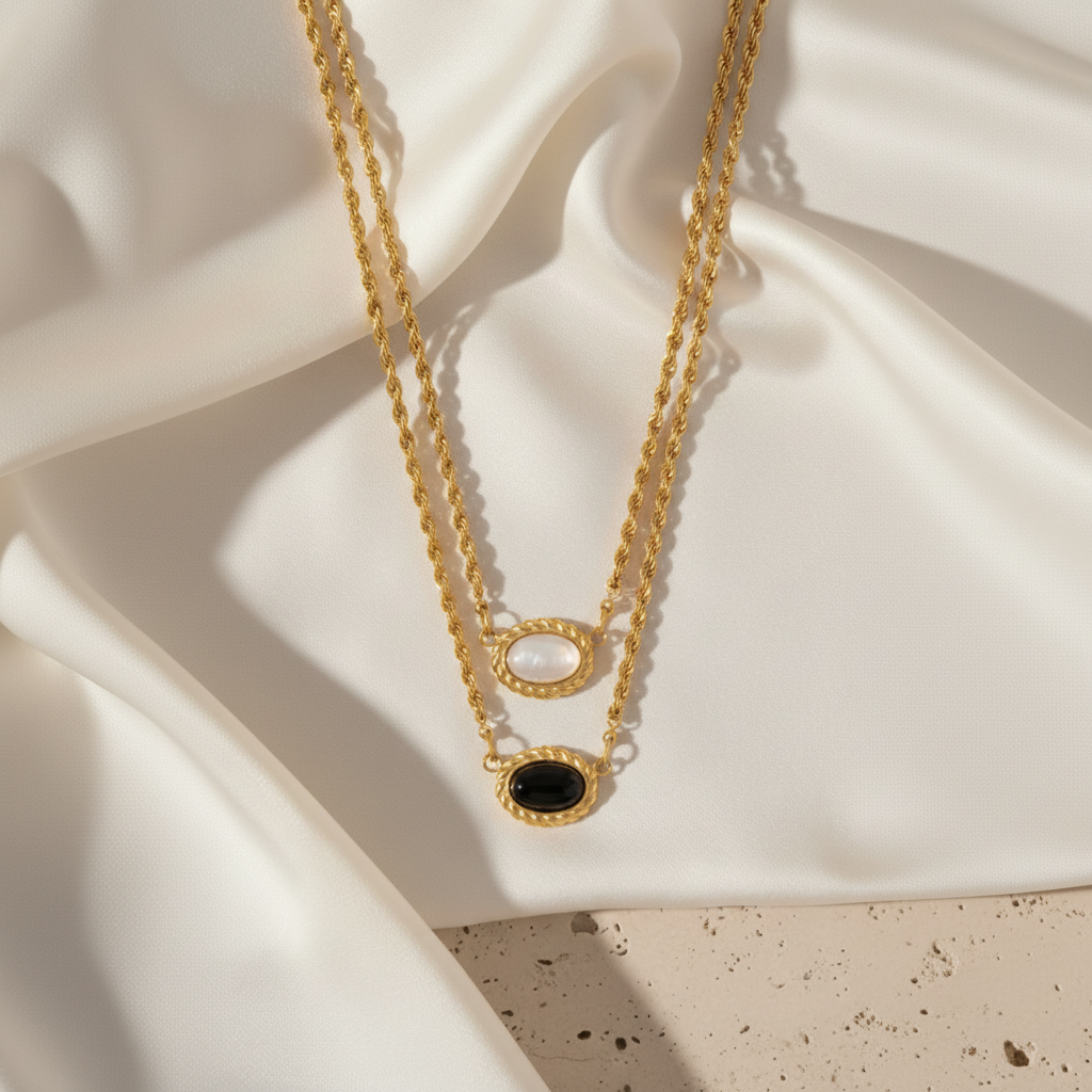 Aurelia gold necklace shown on silky fabric