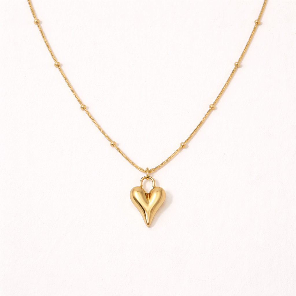 Gold heart-shaped pendant necklace on a white background