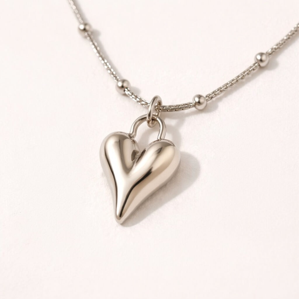 Close-up of silver heart-shaped pendant necklace