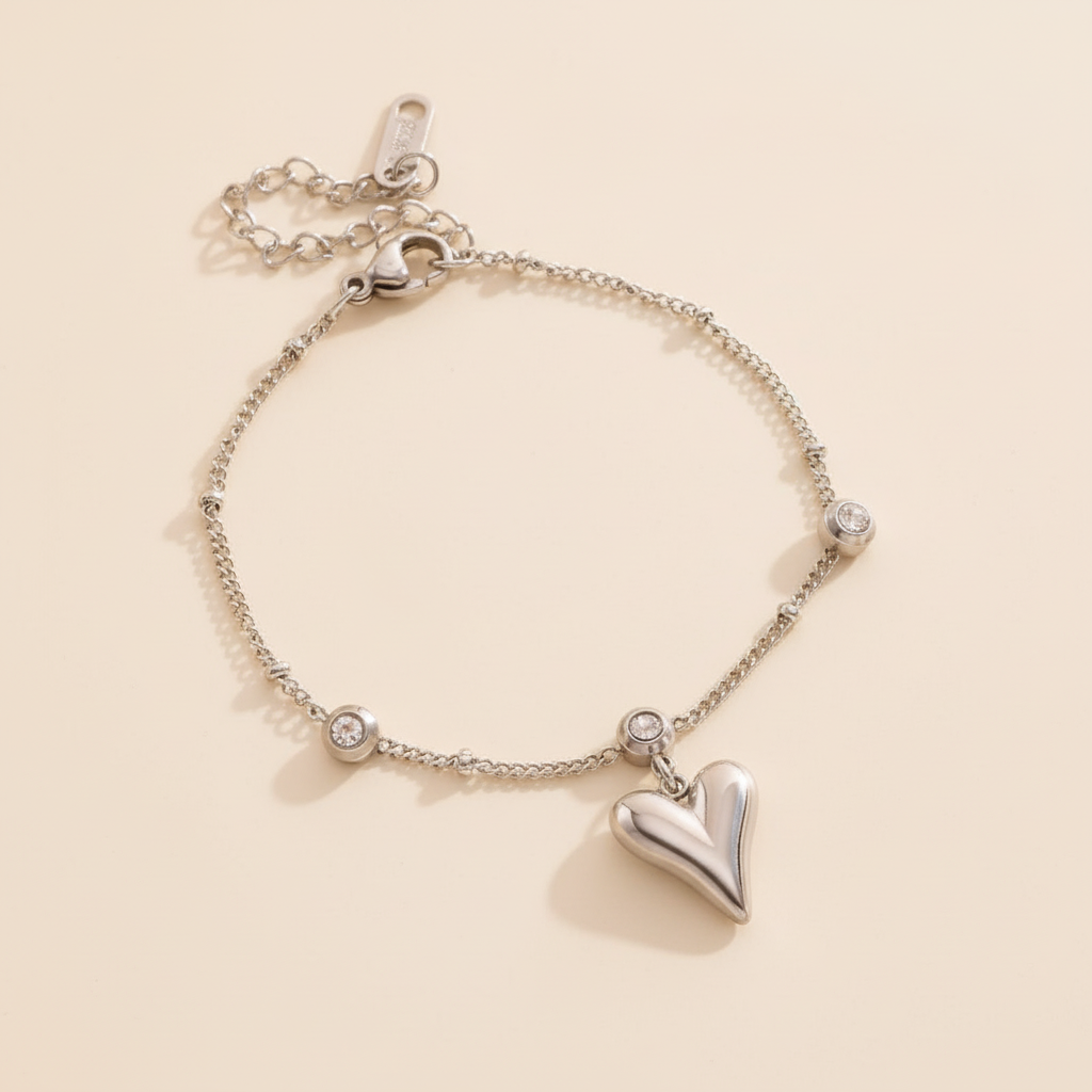 Silver heart-shaped bracelet on a beige background