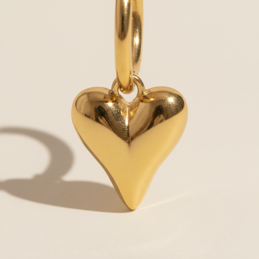 Detail of gold heart charm earrings