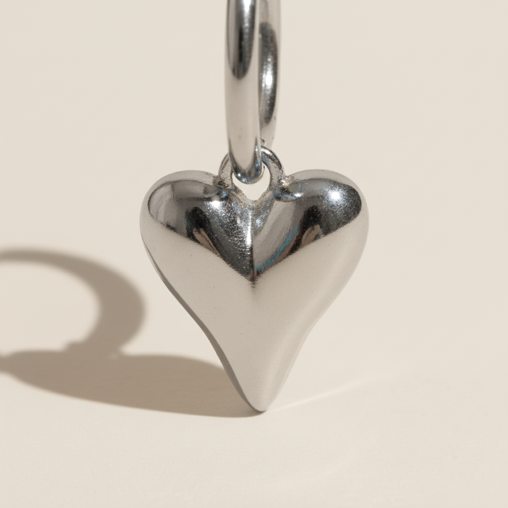 Detail of silver heart charm earrings