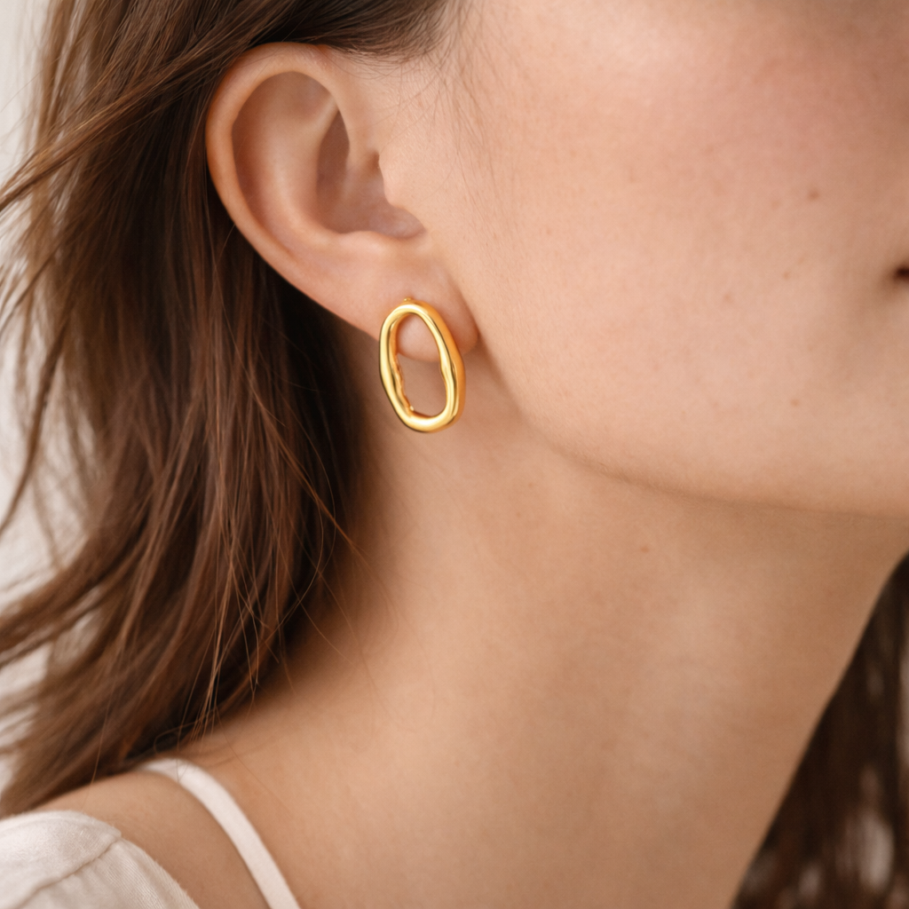 Model shot of oval earrings in gold
